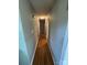 Long hallway with hardwood floors and access to bedrooms at 1217 Burke Rd, Shelby, NC 28152