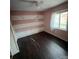 Pink and white bedroom with dark brown laminate flooring at 1309 Poplar Cir, Newton, NC 28658