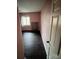 Empty bedroom with dark brown laminate flooring and pink walls at 1309 Poplar Cir, Newton, NC 28658