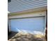 White double-car garage door with brick accents at 1309 Poplar Cir, Newton, NC 28658