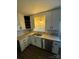 Kitchen with white cabinets, double sink, and stainless steel dishwasher at 1309 Poplar Cir, Newton, NC 28658