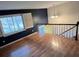 Living room with hardwood floors, window, and access to staircase at 1309 Poplar Cir, Newton, NC 28658