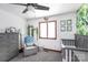 Charming Bedroom features a gray dresser, comfy chair, and a crib at 1432 Jules Ct, Charlotte, NC 28226