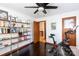 Spacious home office with Peloton, built-in shelving, and hardwood floors at 1432 Jules Ct, Charlotte, NC 28226