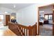 Upper hallway with wooden railing and bedroom access at 1432 Jules Ct, Charlotte, NC 28226