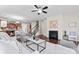 Cozy living room featuring a fireplace, ceiling fan, comfortable seating, and lots of natural light at 1527 Sunflower Field Pl, Matthews, NC 28104