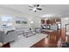 Bright living room with stylish furnishings, wood floors, and a seamless flow into the kitchen at 1527 Sunflower Field Pl, Matthews, NC 28104