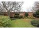 Landscaped backyard with brick wall and lush greenery at 1575 Herlong Ct, Rock Hill, SC 29732