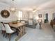 Open dining area with rustic table and modern light fixture at 1575 Herlong Ct, Rock Hill, SC 29732