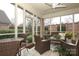 Cozy screened porch with wicker furniture and ceiling fan at 1575 Herlong Ct, Rock Hill, SC 29732