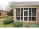 Screened porch with wicker furniture and backyard view at 1575 Herlong Ct, Rock Hill, SC 29732