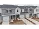 Modern townhome community with gray siding and two-car garages at 1608 Village Grove Ln, Monroe, NC 28110