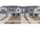 Modern townhome community with gray siding and two-car garages at 1608 Village Grove Ln, Monroe, NC 28110