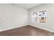 Simple bedroom with hardwood floors and two windows at 1608 Village Grove Ln, Monroe, NC 28110