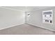 Well-lit bedroom featuring neutral walls and carpet at 1608 Village Grove Ln, Monroe, NC 28110