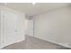 Simple bedroom with grey carpet, white doors and neutral walls at 1608 Village Grove Ln, Monroe, NC 28110