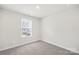 Cozy bedroom with a window and neutral decor at 1608 Village Grove Ln, Monroe, NC 28110