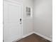 Simple entryway with wood floor and white door at 1608 Village Grove Ln, Monroe, NC 28110