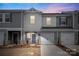 Modern two-story townhome with gray siding and two-car garage at 1608 Village Grove Ln, Monroe, NC 28110