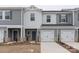 Modern two-story townhome with gray siding and two-car garage at 1608 Village Grove Ln, Monroe, NC 28110