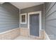 Gray front door with sidelight and brick base at 1608 Village Grove Ln, Monroe, NC 28110