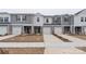 Modern two-story townhome with gray siding and two-car garage at 1608 Village Grove Ln, Monroe, NC 28110