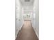 Bright hallway with hardwood floors and two white doors at 1608 Village Grove Ln, Monroe, NC 28110