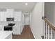 Kitchen with white cabinets, stainless steel appliances, and hardwood floors at 1608 Village Grove Ln, Monroe, NC 28110