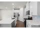 White kitchen with stainless steel appliances and an island at 1608 Village Grove Ln, Monroe, NC 28110