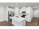 Modern kitchen with white cabinets, island, and stainless steel appliances at 1608 Village Grove Ln, Monroe, NC 28110