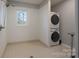 Laundry room with washer, dryer, and built-in shelving at 1652 Brook Dr, Fort Mill, SC 29708