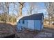 Blue storage shed in wooded backyard setting at 1652 Brook Dr, Fort Mill, SC 29708