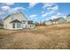 View of home's back elevation and large backyard at 16737 Winston Oaks Ct # 297, Charlotte, NC 28213