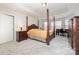 Main bedroom with a post bed, carpeted floors, and an ensuite bathroom at 16737 Winston Oaks Ct # 297, Charlotte, NC 28213