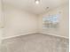 Simple bedroom with neutral walls and carpet flooring at 16737 Winston Oaks Ct # 297, Charlotte, NC 28213