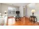 Living room with hardwood floors, sofa, and a large window at 16737 Winston Oaks Ct # 297, Charlotte, NC 28213