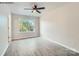 Bedroom with ceiling fan and large window, wood-look floors at 1750 J Julian Ln, Charlotte, NC 28208