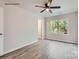 Bedroom with ceiling fan, window, and door to bathroom at 1750 J Julian Ln, Charlotte, NC 28208