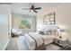 Main bedroom with ceiling fan, large window and wood-like flooring at 1750 J Julian Ln, Charlotte, NC 28208