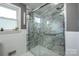 Updated bathroom with a large walk-in shower and marble-style walls at 1750 Melrose Dr, Shelby, NC 28152