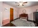 Light pink bedroom with crib, dresser, and dark hardwood floors at 1750 Melrose Dr, Shelby, NC 28152