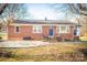 Brick ranch house with a covered porch and landscaped yard at 1750 Melrose Dr, Shelby, NC 28152