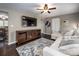 Living room with L-shaped sofa, dark hardwood floors, and large TV at 1750 Melrose Dr, Shelby, NC 28152