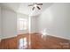 Bright and airy bedroom with hardwood floors and large window at 20215 Middletown Rd, Cornelius, NC 28031