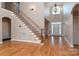 Two-story entryway with hardwood floors and elegant staircase at 205 Micah Ln # 33, Iron Station, NC 28080