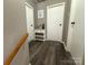 Upstairs hallway with light gray walls and dark gray wood-look floors at 206 King Henry Ln, Gastonia, NC 28056