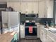 Bright kitchen featuring white cabinets, stainless steel appliances, and a wood countertop at 206 King Henry Ln, Gastonia, NC 28056