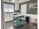 Galley kitchen with green island, white cabinets and stainless steel appliances at 206 King Henry Ln, Gastonia, NC 28056