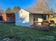 White storage shed with a covered deck and additional storage at 206 King Henry Ln, Gastonia, NC 28056