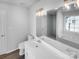 Modern bathroom with double sinks, a large mirror, and a shower at 2115 Windy Hill Ln, Monroe, NC 28110